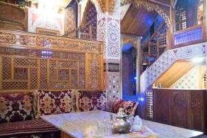 a restaurant with a table in a room with wooden walls at Riad Mehdi Meknès in Meknès
