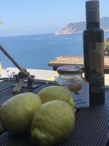 a group ofears and a bottle of oil next to a table at il Magàn - Cinque Terre in Corniglia