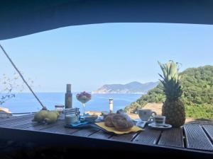 a table with food and a view of the ocean at il Magàn - Cinque Terre in Corniglia