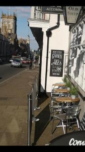 a sidewalk with tables and chairs outside of a restaurant at The Old Ship Inn in Dorchester