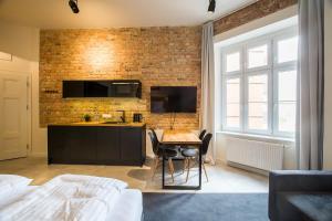 sypialnia ze stołem i ścianą z cegły w obiekcie Loft Apartments Poznań w Poznaniu +37 zdjęć