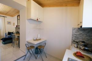 a kitchen with chairs and a table in a room at Under the Windmills in Kondiás +13 photos