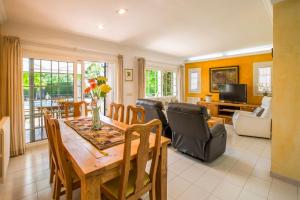 a dining room with a table and chairs and a living room at Sa Coma Dalies in Sa Coma