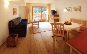 a living room with a table and a dining room at Biotel Bertel Naturappartements in Brand
