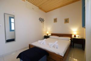 a bedroom with two beds with white towels on them at Under the Windmills in Kondiás