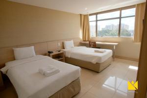 
Cama ou camas em um quarto em Brasília Imperial Hotel e Eventos
