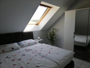 a bedroom with a large bed with a window at Ferienwohnung Panoramablick in Lieser