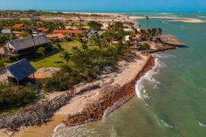 an aerial view of a beach with houses and the ocean at Beach House- KiteAliCori in Ponta do Anel