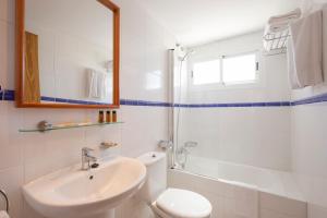 a bathroom with a toilet and a sink and a shower at Cabot Siller Apartment in Port de Pollensa +8 photos