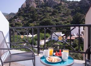 a breakfast table with a view of the mountains at Hotel Asteria in Agios Kirykos