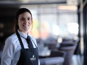 a woman wearing a vest and a tie at MILL Hotel & Spa in Chester
