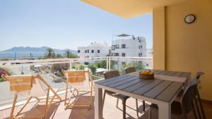 a table and chairs on a balcony with a view of the ocean at Cabot Siller Apartment in Port de Pollensa