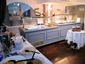 a large kitchen with a counter with plates and food at MILL Hotel & Spa in Chester