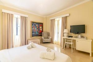 a hotel room with a bed and a television at Cape North West in Parga