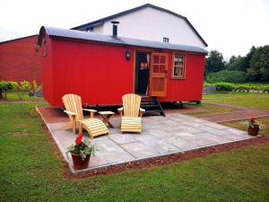 a red tiny house with two chairs and a table at Parkway Hotel & Spa in Newport