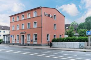 a large red building on the side of a street at Hotel Böll Essen in Essen