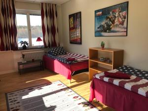 a room with two beds and a window at Hågadalens Hostel & Vandrarhem in Uppsala