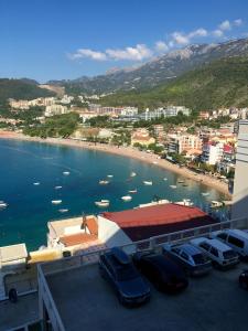 a group of cars parked in a parking lot near a body of water at Luxury Apartments Trend in Budva