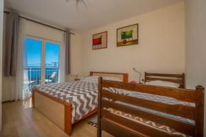 Postel nebo postele na pokoji v ubytování Apartman Zlatica