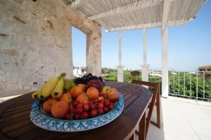 a bowl of fruit on a table on a porch at Villa Belvedere in Ostuni
