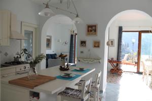 a kitchen with an archway and a table in a room at Villa Flora in Vico Equense