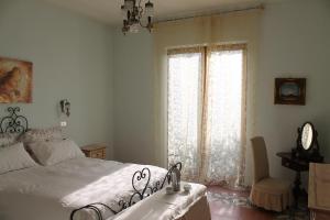 a bedroom with a bed and a large window at Villa Flora in Vico Equense