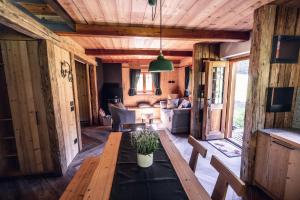 a living room with a wooden table and a couch at Baita Valon - Alpine Hideaway in Comano Terme