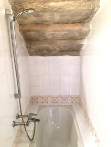 a bath tub in a bathroom with a ceiling at MONOLOCALE CASENUOVE con GIARDINO in Castiglioncello