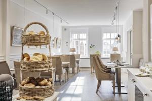 a room with baskets of bread on a table at Duus Hotel garni in Wyk auf Föhr