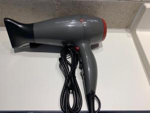 a blow dryer is hanging on a wall at Stay Santiago Lastarria Bellas Artes in Santiago