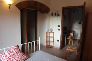 Habitación con cama y puerta abierta en Sul sentiero di Francesco, en Nocera Umbra