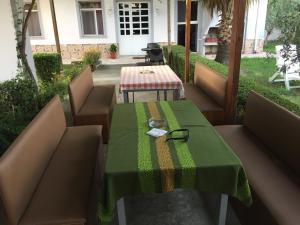 a table with a green table cloth on a patio at Villa Dede Nikolla in Durrës