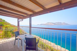 a balcony with a table and chairs and the ocean at Sunset Villa Hotel in Kaş