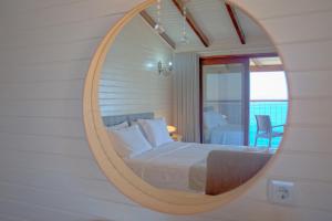 a bedroom with a large circular mirror on the wall at Sunset Villa Hotel in Kaş