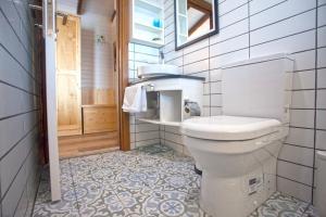 a bathroom with a white toilet and a window at Sunset Villa Hotel in Kaş