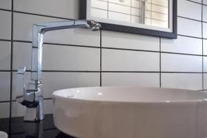 a white sink in a bathroom with a faucet at Sunset Villa Hotel in Kaş