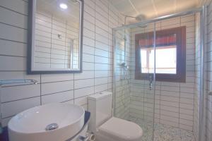 a bathroom with a toilet and a sink and a shower at Sunset Villa Hotel in Kaş