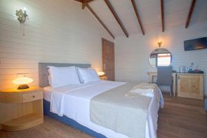 a bedroom with a bed and a table with a chair at Sunset Villa Hotel in Kaş