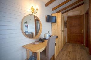 a vanity with a mirror and a table in a room at Sunset Villa Hotel in Kaş