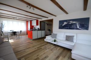 a living room with a white couch and a table at Lake House in Bönigen