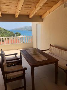 a table and chairs in a room with a balcony at Mediterranean Apartment With Great Sea View in Marina