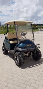 a small golf cart parked on a beach at Marinagri Resort in Policoro