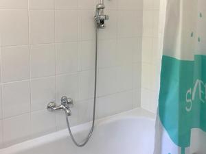 a shower in a bathroom with a tub at Haus am Hagen in Friedland