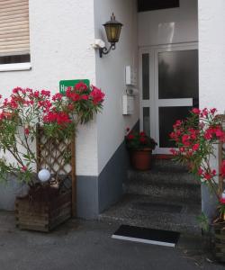 a front door of a house with flowers on it at Haus Edith Privathaus mit Gästezimmern in Bregenz