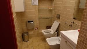 a small bathroom with a toilet and a sink at Masseria Donna Laura di Adriana Giangrande in Arnesano +28 photos