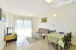 a living room with a table and a couch at Apartments Marta in Duće
