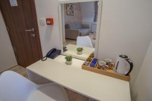 a room with a desk with a mirror and a room with a couch at Hotel Polar Star in Žabljak