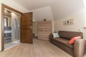 a living room with a couch and a closet at Willa Vela in Władysławowo +154 photos