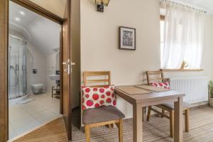 a dining room with a wooden table and chairs at Willa Vela in Władysławowo