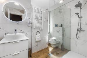 a bathroom with a shower and a sink and a mirror at InCenter Apartments Rijeka in Rijeka